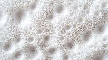 Microscopic white foam suggesting creating textural pattern, bubbles purity and softness in skincare, cleaning, and graphic design contexts photo