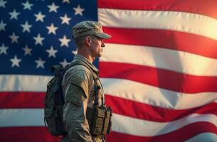 A soldier stands resolutely in front of the American flag during sunset, showcasing dedication and patriotism in a heartfelt moment photo