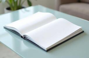 An open blank notebook resting on a glass table in a well-lit room with indoor plants and modern furniture photo