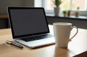 A cozy work setup featuring a laptop, a coffee cup, and a plant on the desk in a bright and inviting workspace photo