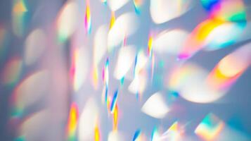 Light refracts through a crystal creating colorful patterns on a wall in a sunny room photo