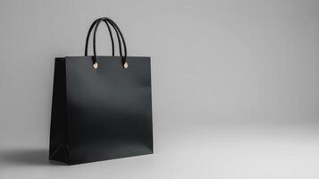 Black shopping bag on a light grey background showcasing minimal design photo