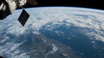 View of Earth from the International Space Station showcasing clouds and ocean at sunrise over a coastal region photo