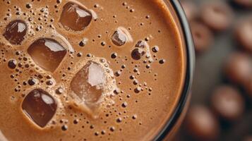 Rich chocolate beverage with ice cubes and frothy texture, perfect for warm days, indulgent treat for chocolate lovers, refreshing drink concept photo