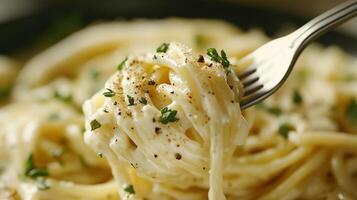 Creamy pasta dish served with herbs and spices on a fork close-up in a cozy dining setting, showcasing culinary details photo