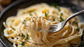 Delicious spaghetti served with creamy sauce and fresh herbs on a cozy dining table photo