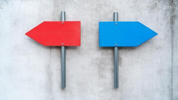 Colorful directional signs indicating routes on a textured wall in an urban setting during daylight hours photo
