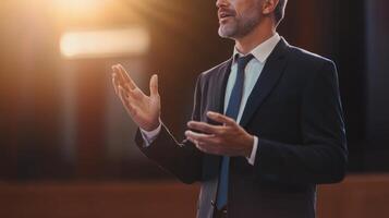 Business professional engaging an audience during a public speaking event in a well-lit venue photo
