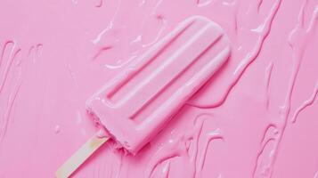 Deliciously refreshing pink popsicle melting on a vibrant pink surface during a warm summer day photo