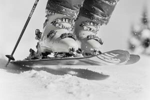 Ski boots gripping snow while preparing for a downhill run in a winter landscape photo