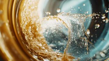 Dynamic splash of water creates ripples in a glass container illuminated with warm light photo