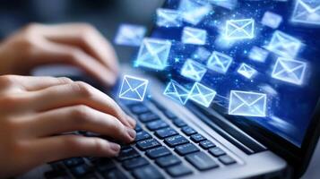 Digital communication through email is showcased as a person types on a laptop while messages are sent and received photo