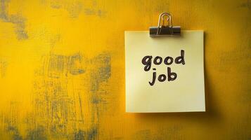 Simple yellow sticky note with positive message displayed on a textured wall background photo