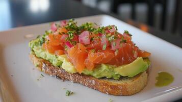 Delicious avocado toast topped with smoked salmon, diced tomatoes, and herbs served in a cozy cafe setting photo