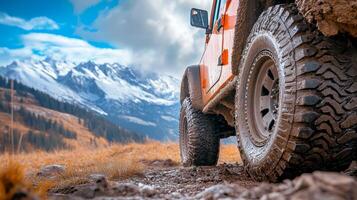 Off-road adventure with a rugged vehicle navigating a mountainous terrain under a bright sky photo