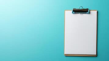 Blank clipboard ready for notes or drawings against a bright teal backdrop in a clean workspace photo