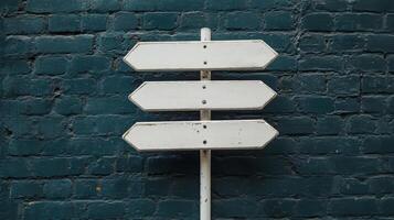 Directional signpost standing against a textured blue brick wall during daytime, showcasing multiple options for navigation and exploration photo