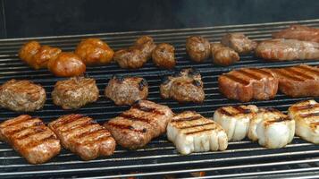 Grilling various types of meat on an outdoor barbecue during a sunny afternoon gathering photo