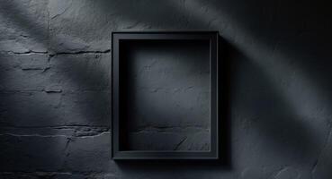 Empty black frame on a wall with shadows photo