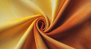 Abstract Swirl of Yellow and Orange Fabric, Capturing Light and Shadow in Textile Art. photo