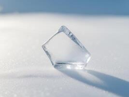 Ice Cube on a Snowy Surface, Abstract Cold Still Life with Shadow and Texture photo
