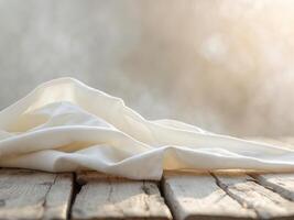 Rustic Wood Table with Cream Fabric and Blurred Light Background Closeup View. photo