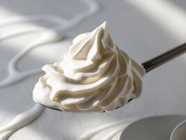 A spoon with whipped cream on it photo