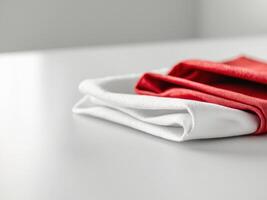 Folded White and Red Napkins on a White Table, Clean and Minimalist Still Life photo