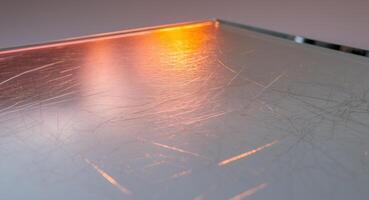 Surface with Scratches and Light Reflection, Giving an Abstract and Textured Look. photo