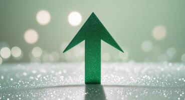 A green arrow pointing upward on a shiny surface photo
