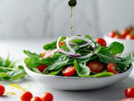 A salad with tomatoes, onions and spinach is being poured over it photo