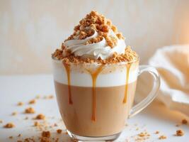 A coffee drink with whipped cream and caramel drizzle photo