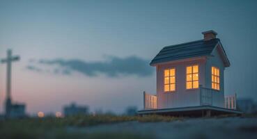 A miniature house sits on top of a hill at dusk photo