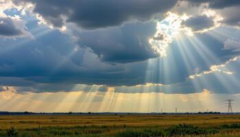 dark clouds pass over a wide prairie as sunlight breaks through in dramatic beams. photo