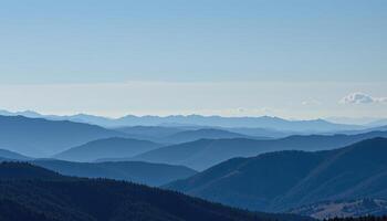 a line of mountains fades into the distance, each ridge becoming bluer with space. photo