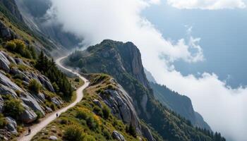 a narrow mountain path winds along a steep cliff, partially hidden by mist. photo