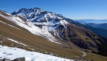 the last traces of snow melt on the south facing slopes of a spring mountain. photo