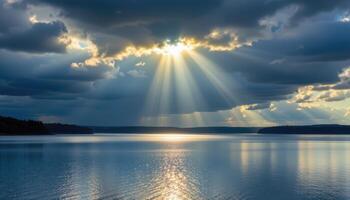 a single shaft of sunlight breaks through storm clouds onto a distant lake. photo
