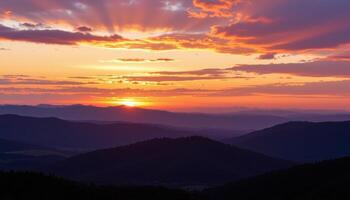 the sky turns violet and gold above the horizon of rolling hills. photo