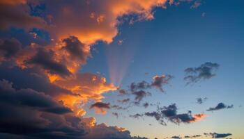 the last light of day lingers on the edges of distant clouds as night begins to fall. photo