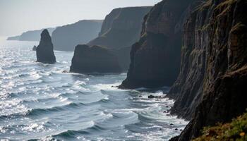 rain darkened cliffs glisten against the backdrop of a silver sea. photo