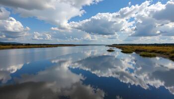 a wide estuary reflects shifting clouds in its slow moving tidal waters. photo