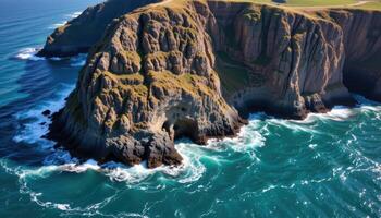 high cliffs loom above the ocean, casting long shadows over breaking waves. photo