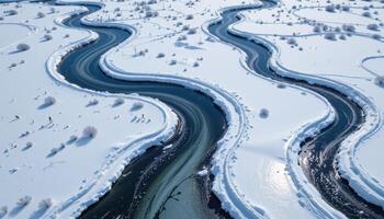 a network of frozen rivers cuts patterns through a snowy wilderness. photo
