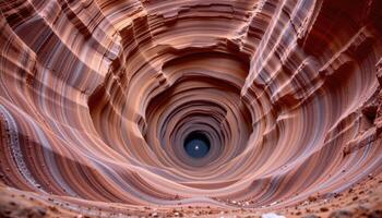 a spiral canyon with layers of red and gold sandstone winding downward. photo