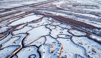 a wide tundra where patches of snow and frost form intricate patterns. photo