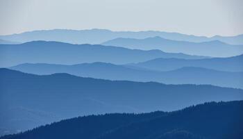 a layered mountain range fading into blue haze as they reach the horizon. photo