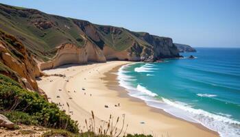 a pale sand beach bordered by tall cliffs and quiet, lapping waves. photo