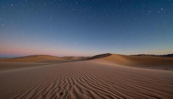 a gently rolling dune field under a star filled sky, each crest traced by moonlight. photo