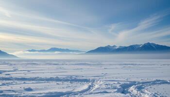 a flat glacial plain with far off mountains shrouded in ice fog. photo